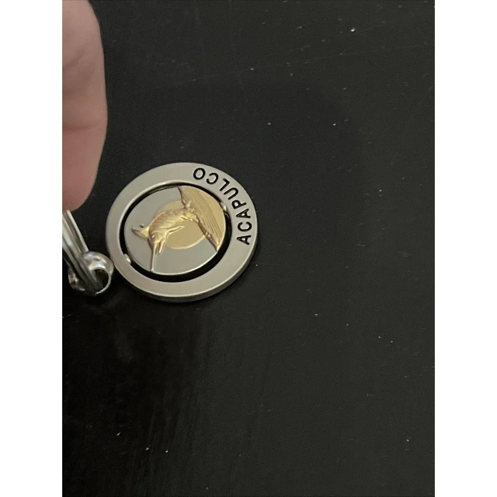 round metal Acapulco‎ souvenir keychain featuring a sailfish design